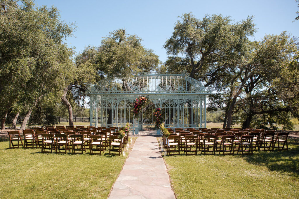 Outdoor wedding ceremony setup with aisle and floral-decorated Green Cathedral