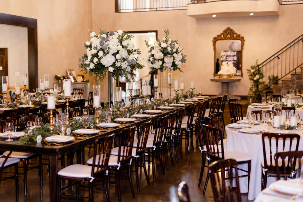 Elegant wedding reception with tall floral centerpieces