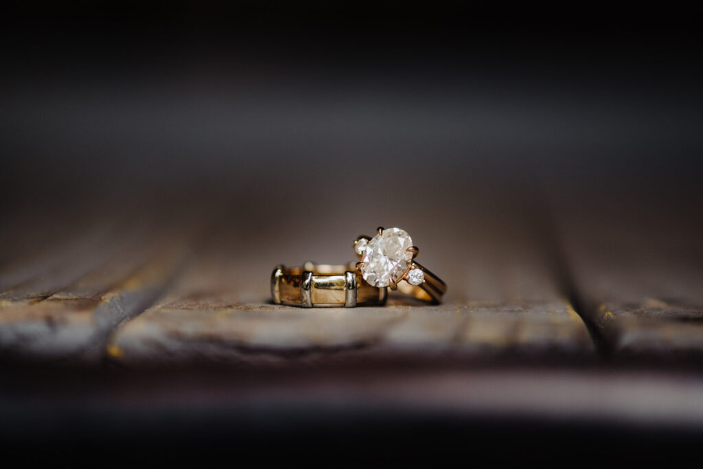 Close-up of Nicole and Jacob’s gold wedding rings
