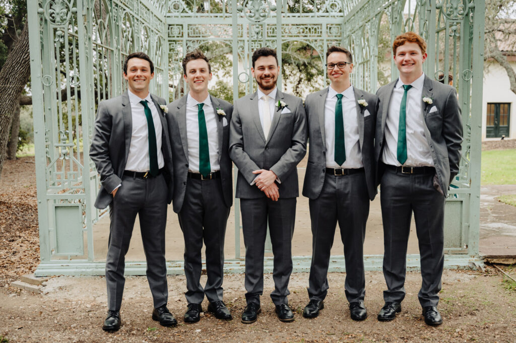 Groom and groomsmen pose at Ma Maison’s Green Cathedral