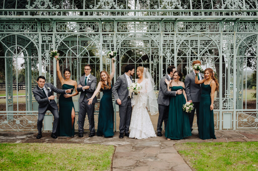 Full wedding party celebrating outside the Green Cathedral