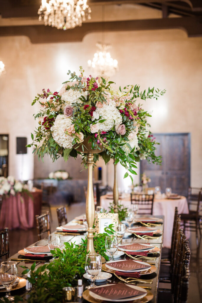 Elegant indoor reception setup with tall floral arrangements at Ma Maison