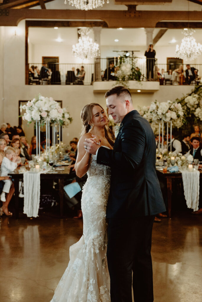 A newlywed couple shares their first dance at Ma Maison who's sharing an idea of an average cost of a wedding in Austin