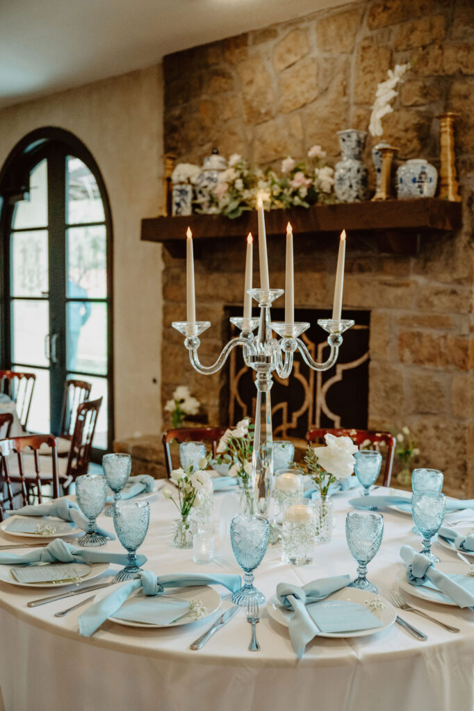 Luxurious wedding reception table at Ma Maison, set with soft blue accents, candlelit elegance, and European-inspired charm