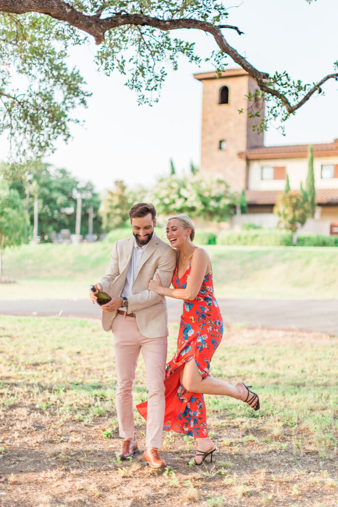 Surprise engagement photo at Ma Maison’s Tunnel of Love surrounded by blooming flowers. Beautiful French Country sire in the wine region of the Texas Hill Country