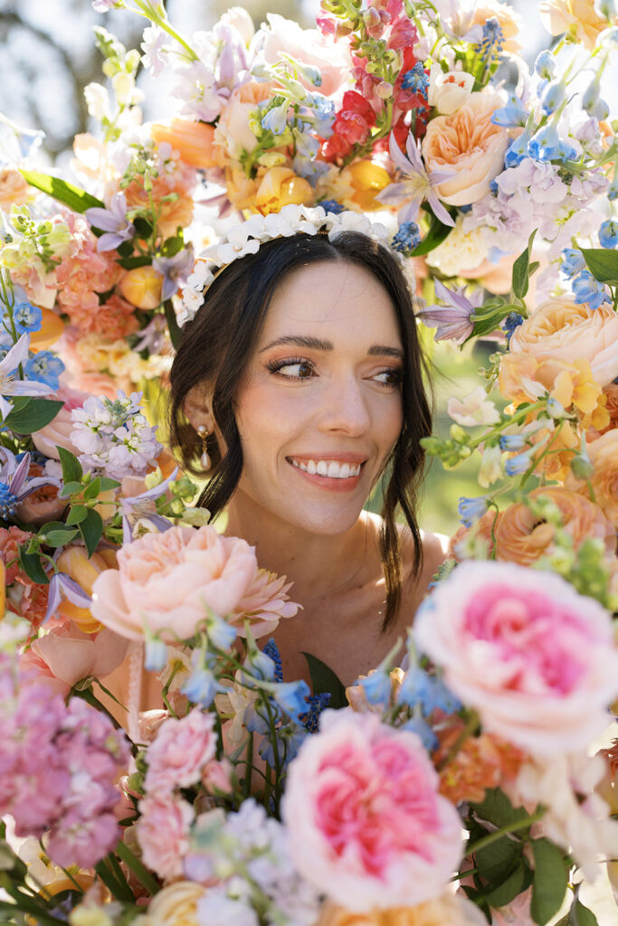 A bride’s portrait surrounded by pastel peonies, roses, and muscari illustrating flowers for wedding photography