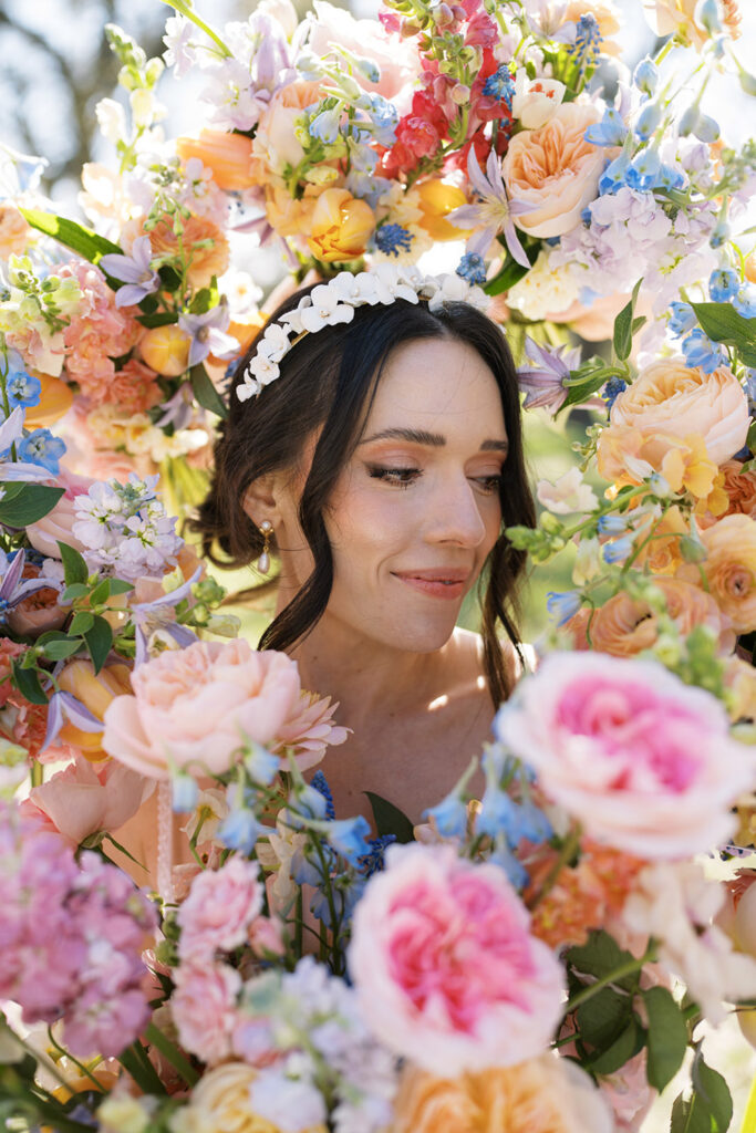 A detailed shot of mixed peach roses and pale blue delphiniums highlighting seasonal flowers for wedding design