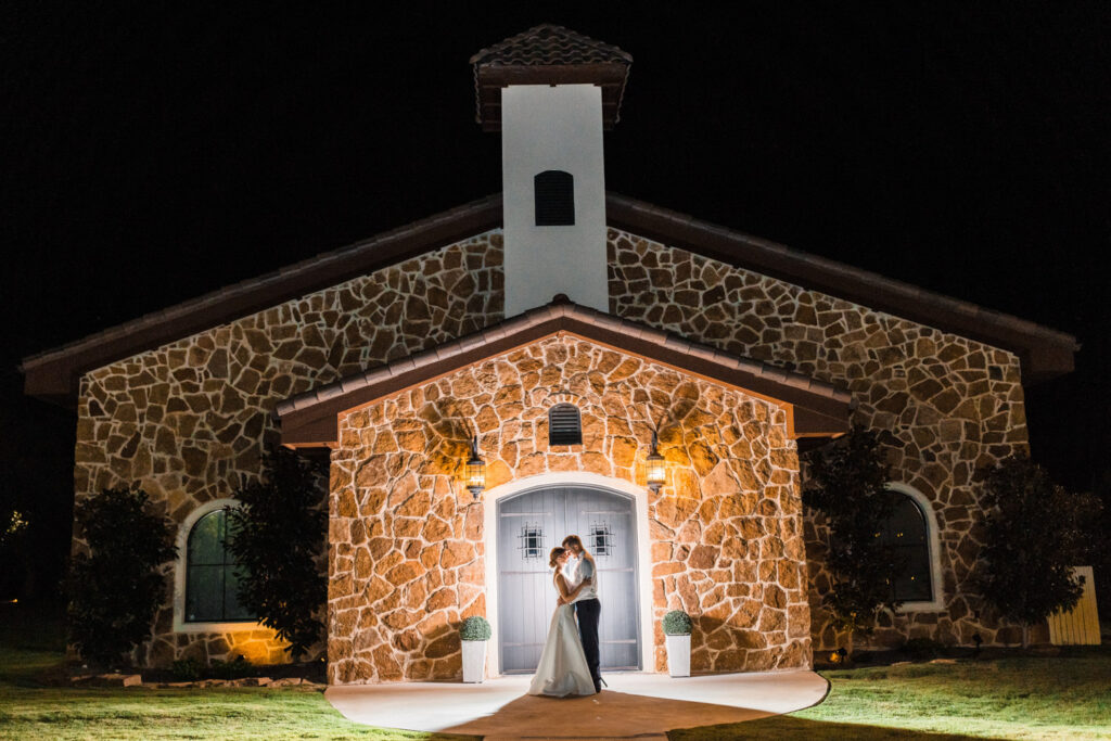 Bride and groom in front of stone chapel highlighting how to choose wedding vendors