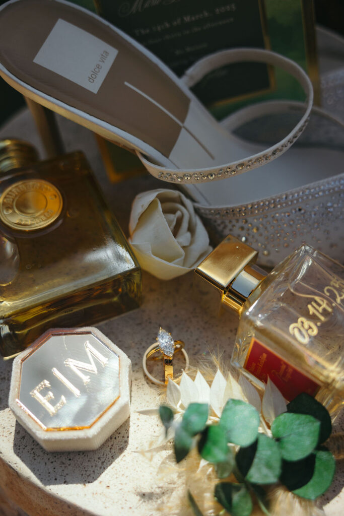 Flat lay with heels, perfume, and ring box showcasing lab-grown diamonds