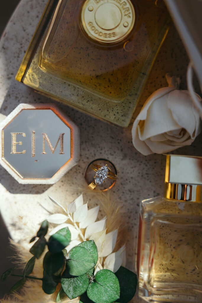 Bright marquise-cut lab-grown diamond ring beside perfume and florals