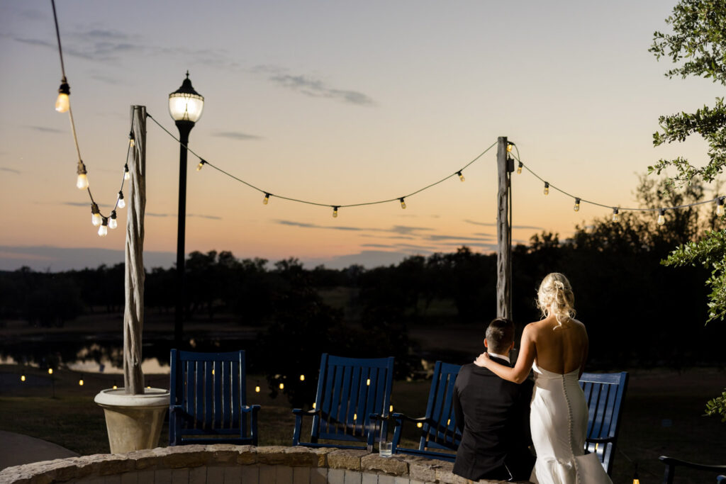 Bride and groom relaxing at sunset in a peaceful Dripping Springs setting