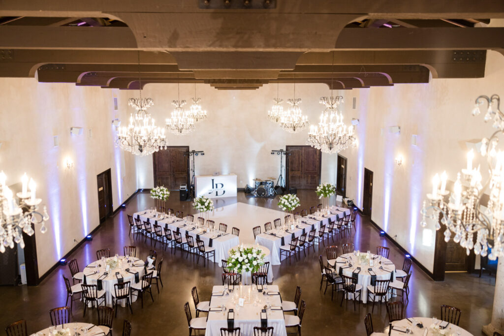 Romantic wedding reception setup in Dripping Springs with elegant chandeliers and florals