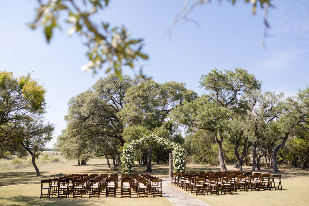Outdoor ceremony space with floral arch at a romantic Dripping Springs location