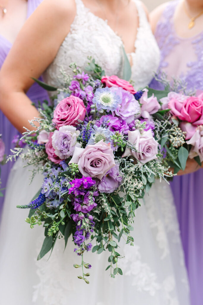 Bride and bridesmaids with elegant floral bouquets.