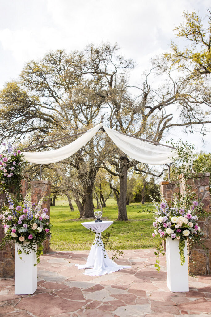 Floral ceremony altar with draped fabric at a unique wedding venue in Austin