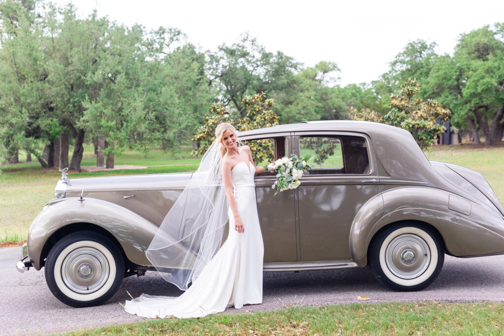 Elegant wedding design featuring a bride in a classic gown with vintage car