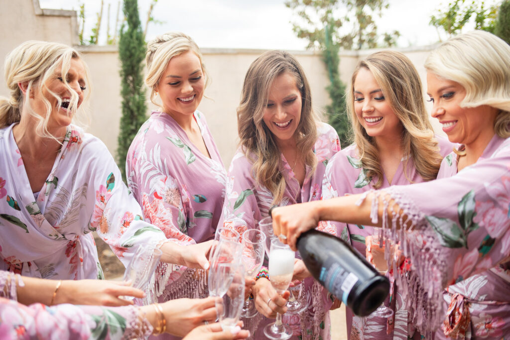 Wedding design moments with bridesmaids celebrating in matching robes