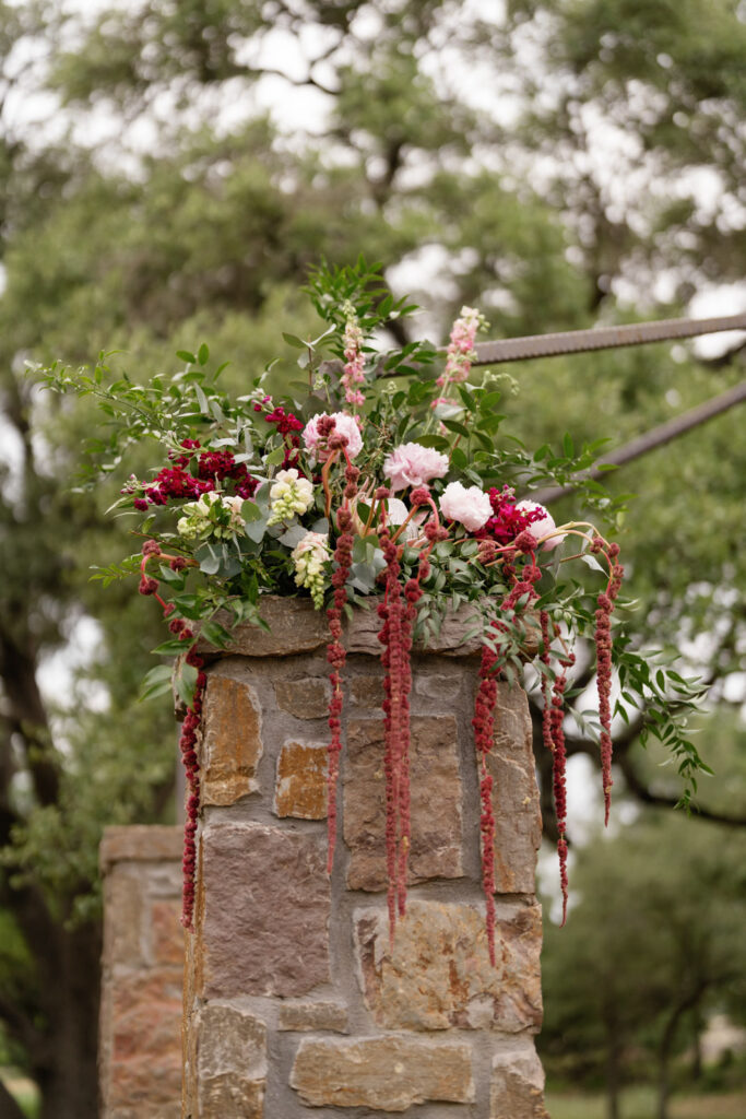 Rustic ceremony backdrop with florals