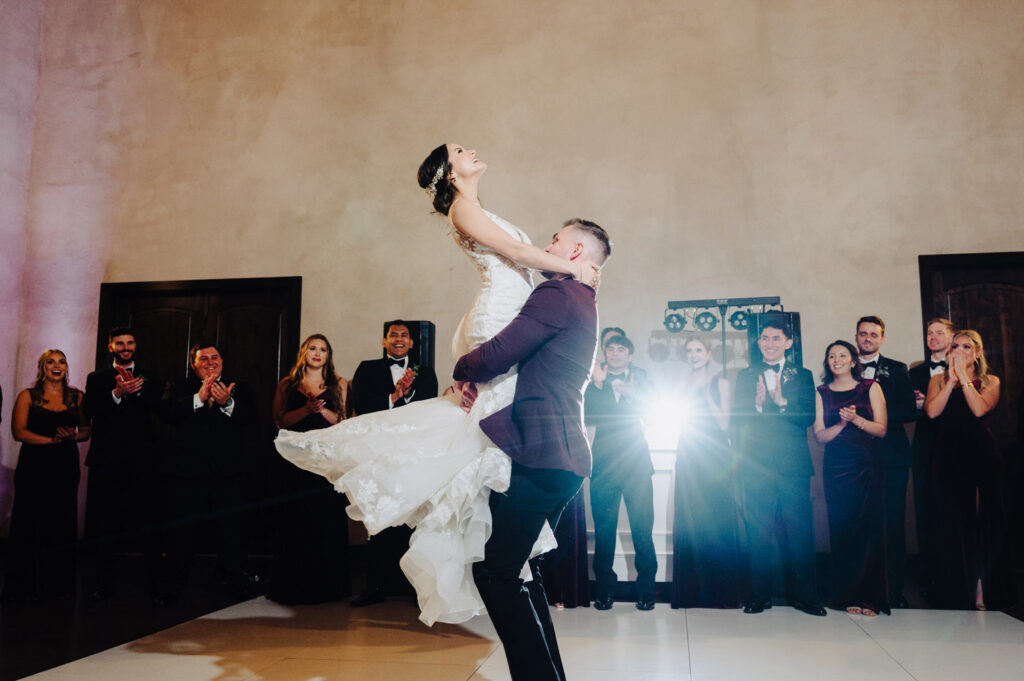 Bride lifted during first dance captured by a wedding videographer in Austin