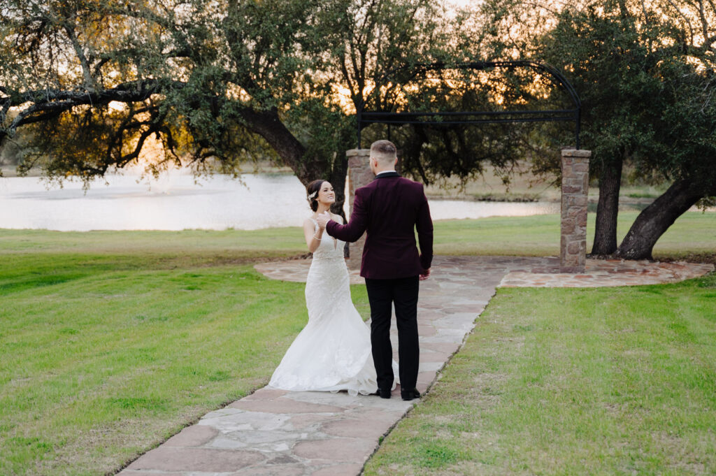 Outdoor ceremony stroll with trees and lake backdrop