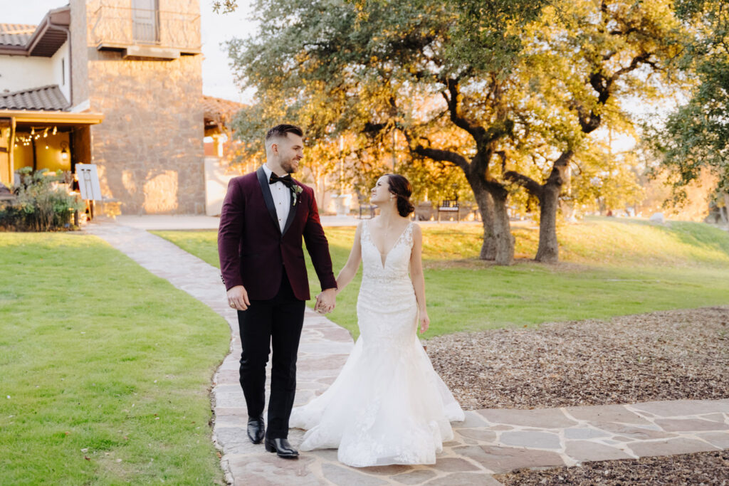Bride and groom at Ma Maison holding hands while walking