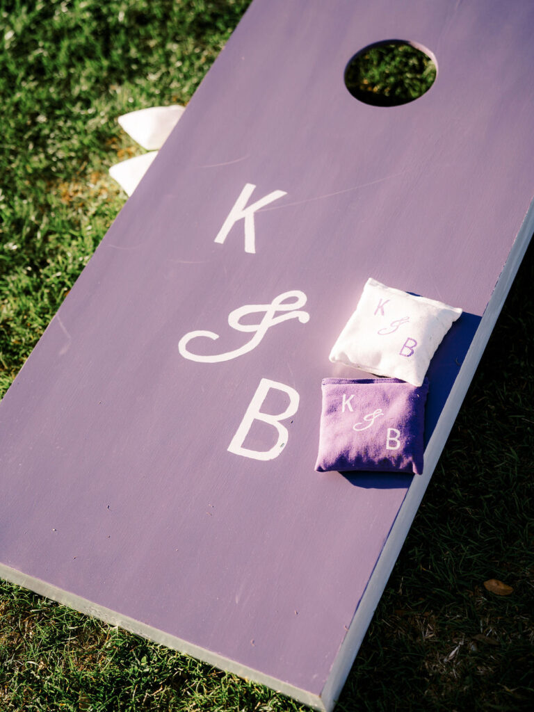 Custom cornhole game with initials showing playful wedding vision