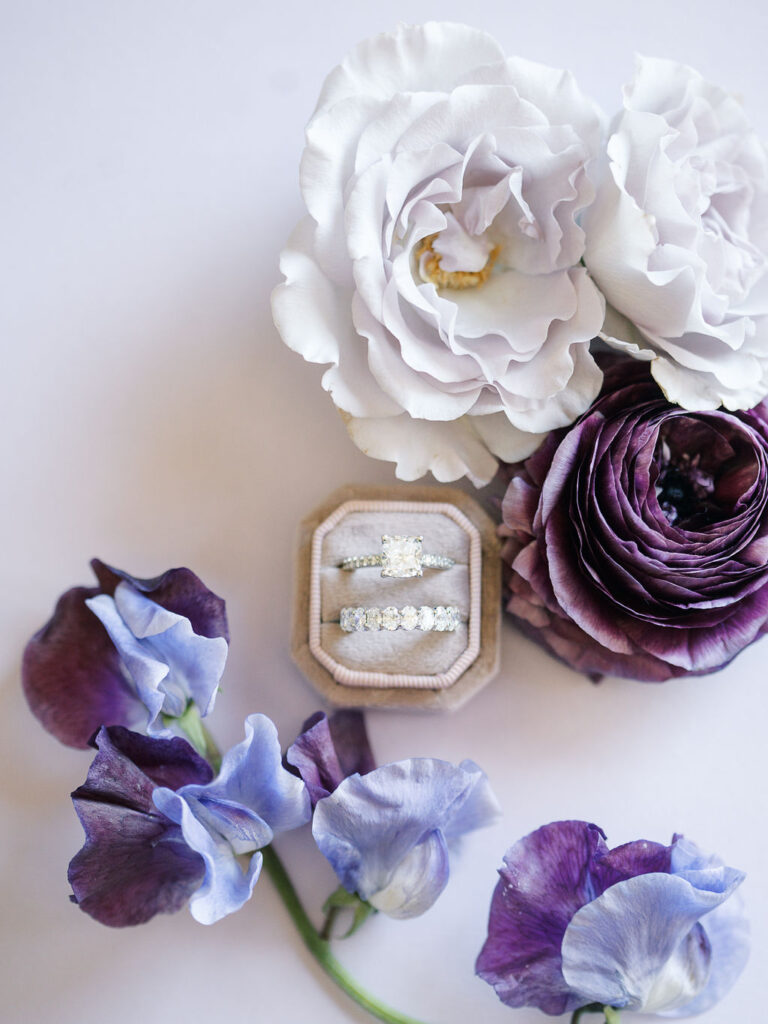 Wedding rings with purple flowers symbolizing elegant