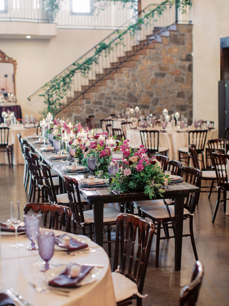 Reception tables with floral arrangements styled for wedding