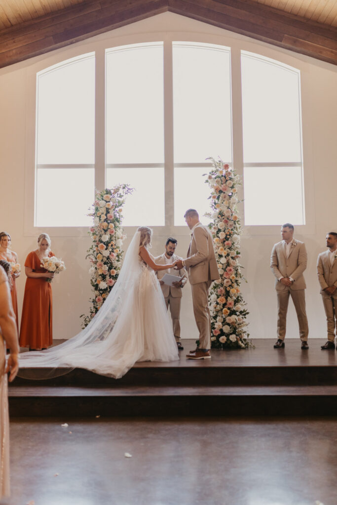 Wedding vows with floral installations that include blooms prone to drooping