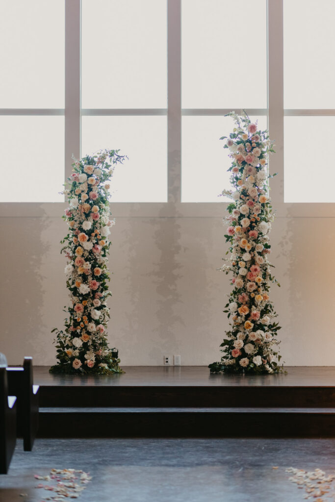 Empty ceremony setup showing two large floral pillars made of blooms